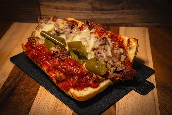 Open-faced sandwich with meat and peppers.