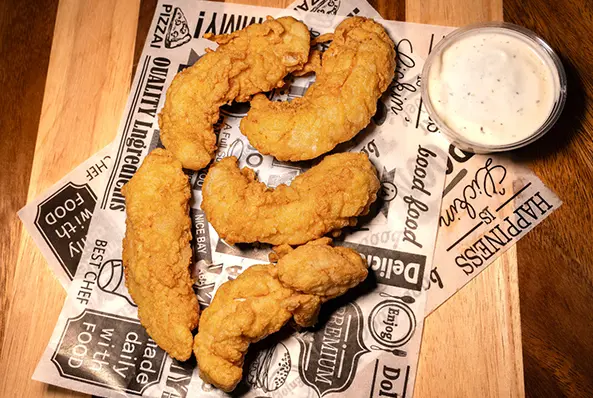 Fried chicken tenders with dipping sauce.
