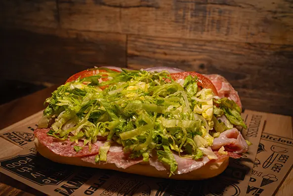 Sub sandwich with lettuce and tomatoes.