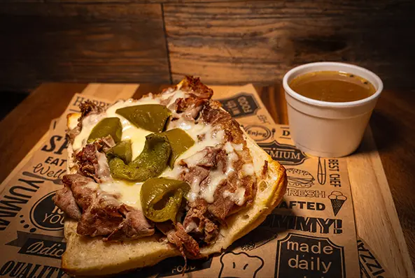 Open sandwich with beef, cheese, jalapeños, sauce.
