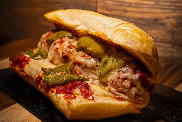 Meatball sub sandwich with green peppers.