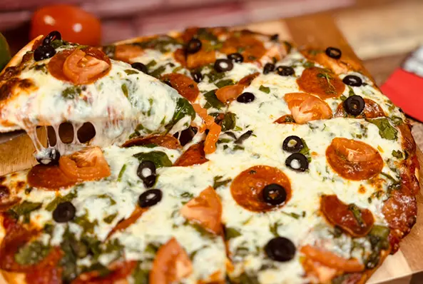 Pizza with olives, tomatoes, and cheese.