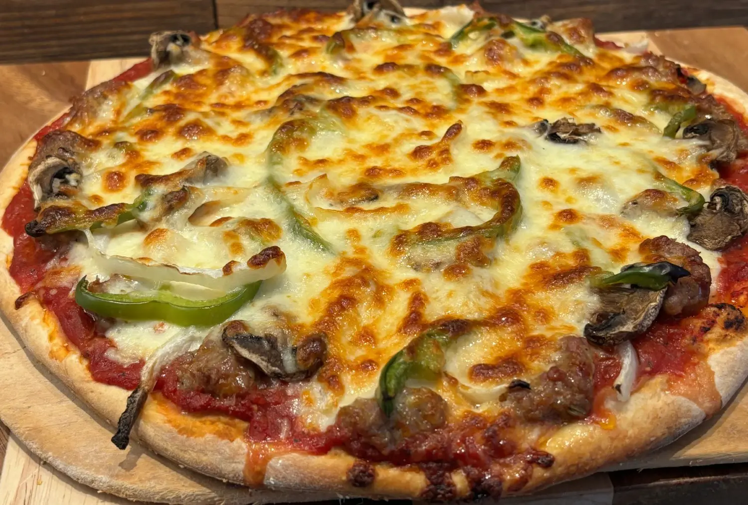 Cheese pizza with mushrooms and green peppers.