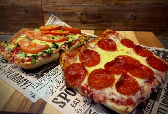Two slices of pizza with various toppings.
