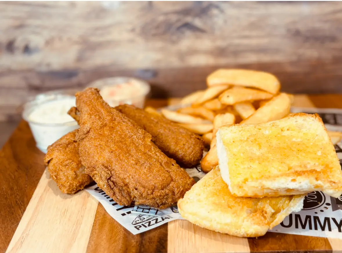 Fried fish, fries, toast, and sauces.