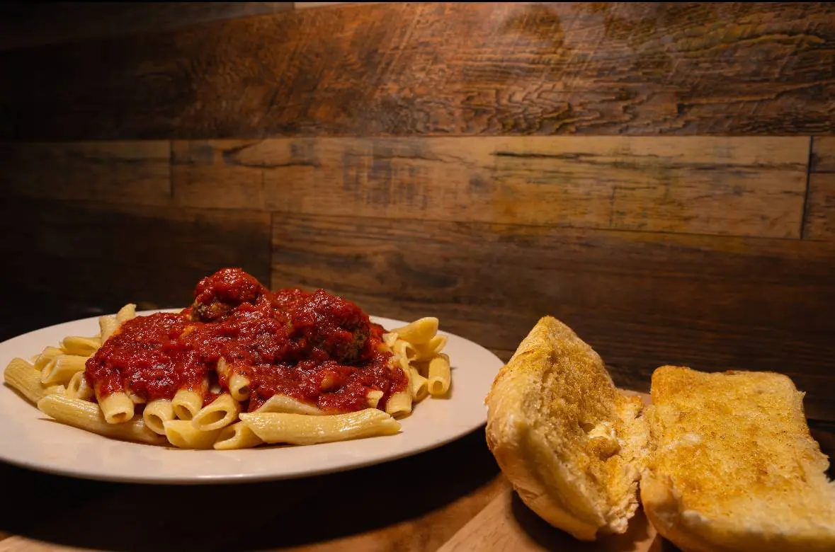 Pasta with meatballs and garlic bread.