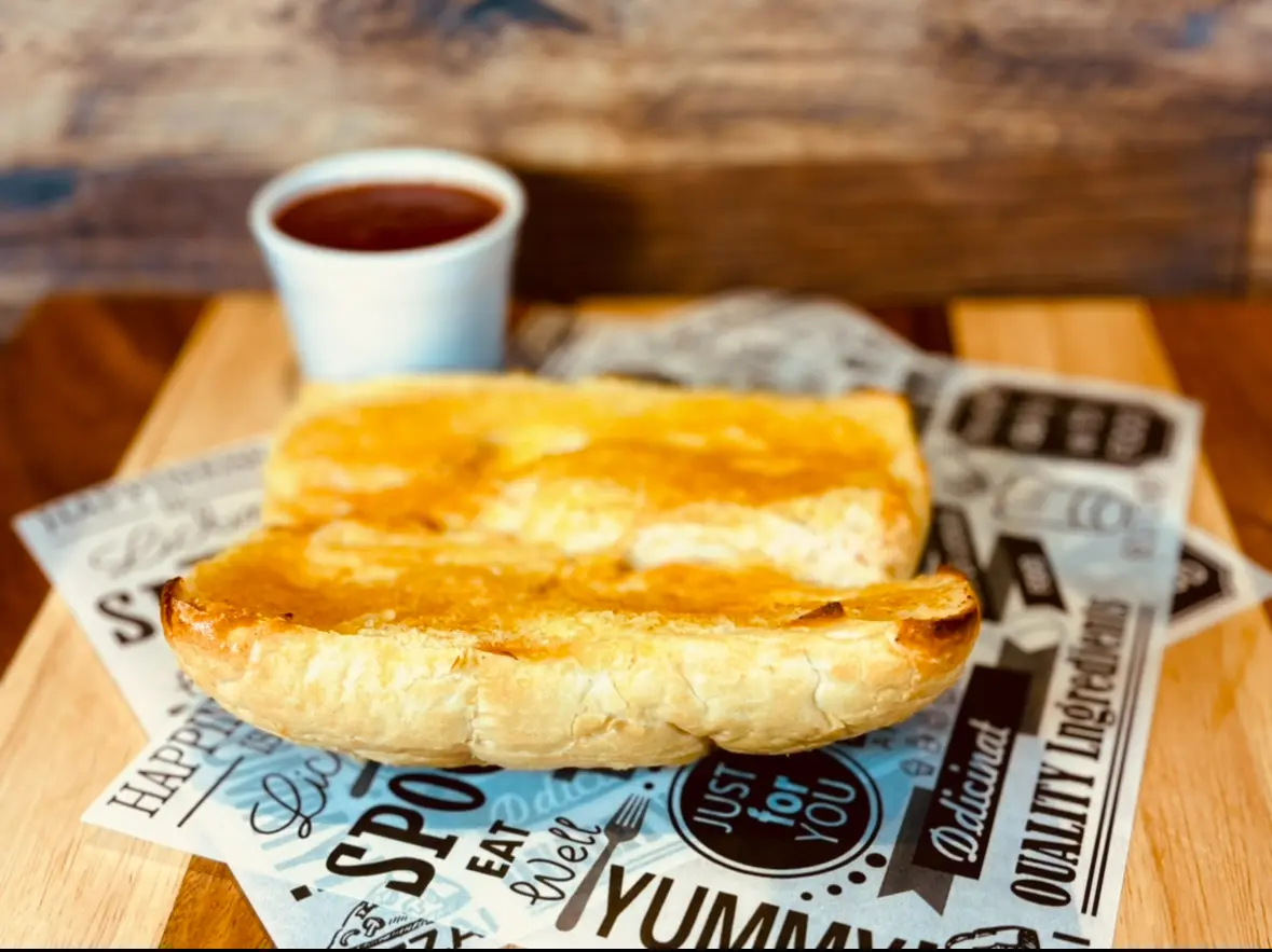 Toasted bread with sauce on decorative paper.