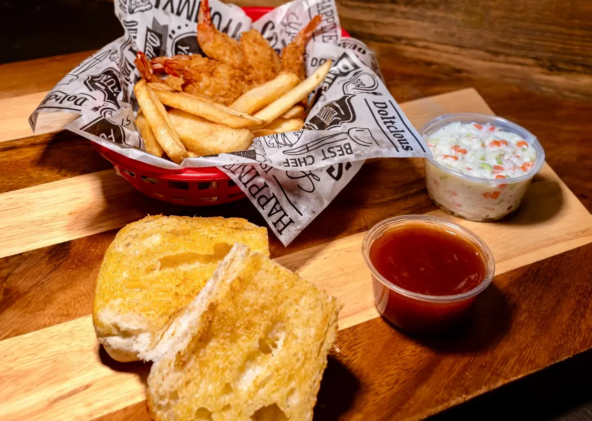 Fried shrimp with fries and coleslaw.