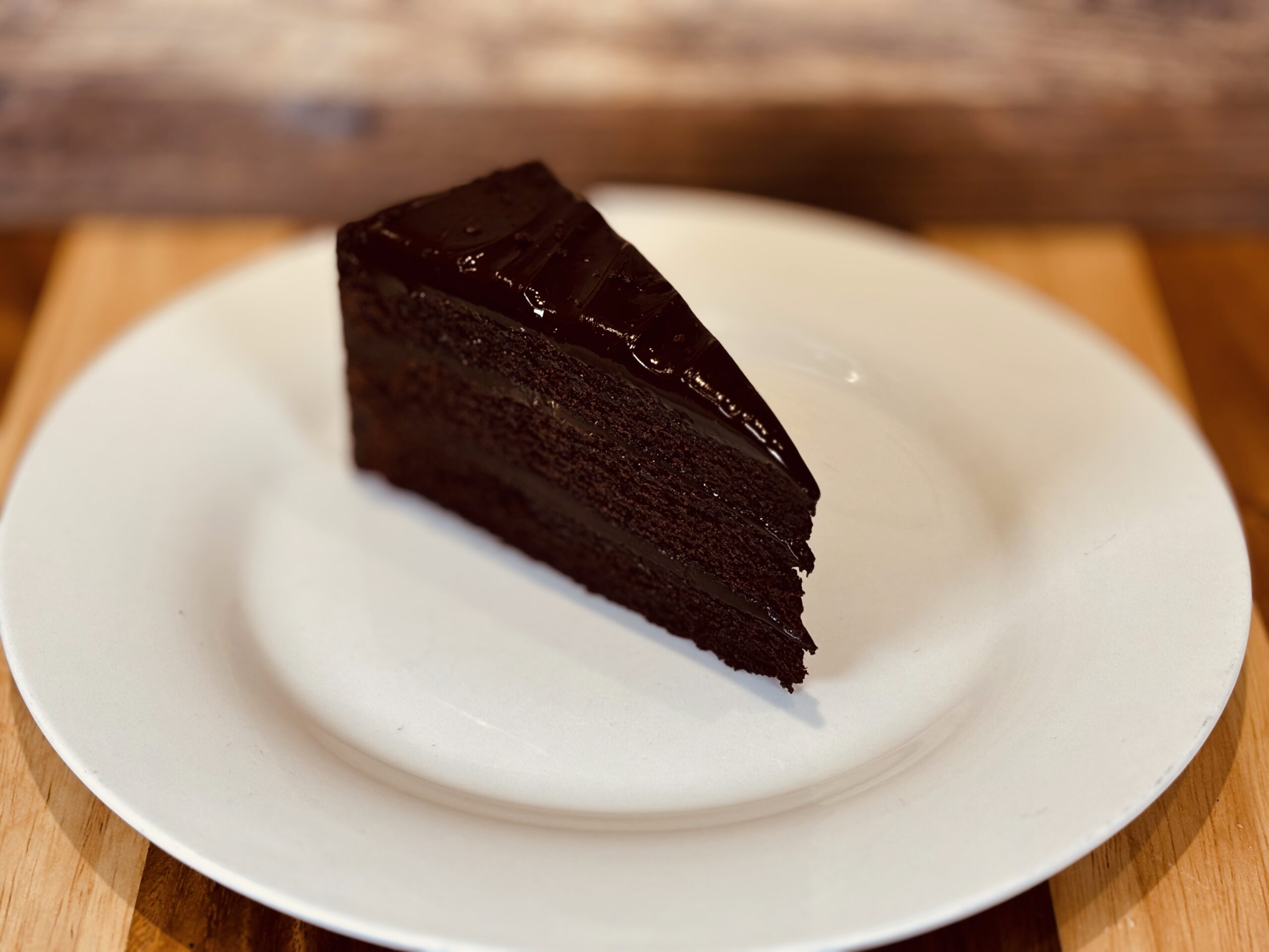 Slice of rich chocolate cake on plate.